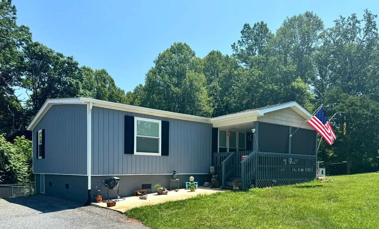 Light blue lap siding with black shutters