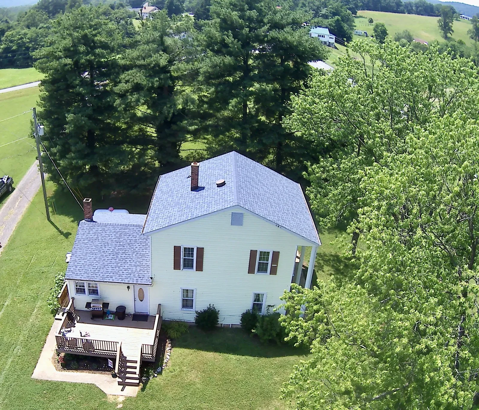Aerial view of a roof and yard trees near Roanoke, VA