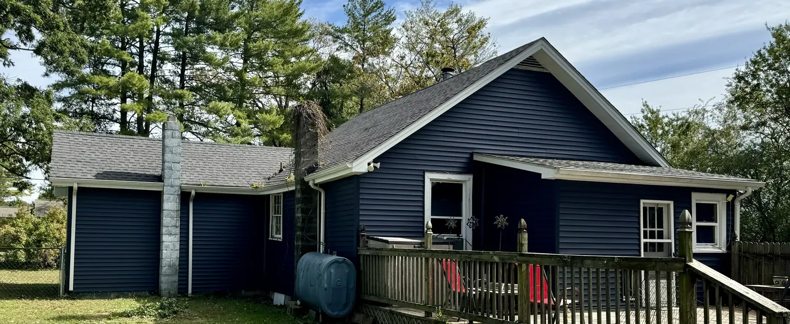 Navy home with gutters near trees in Thaxton, VA
