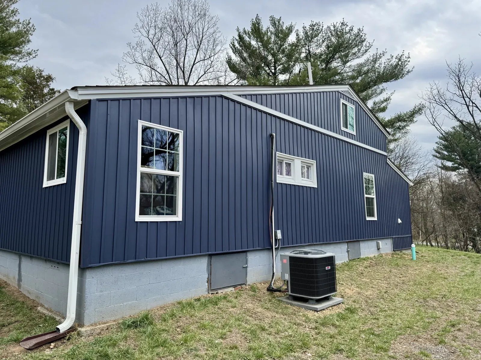 Navy siding with white gutters on a two-story home in Vinton, VA
